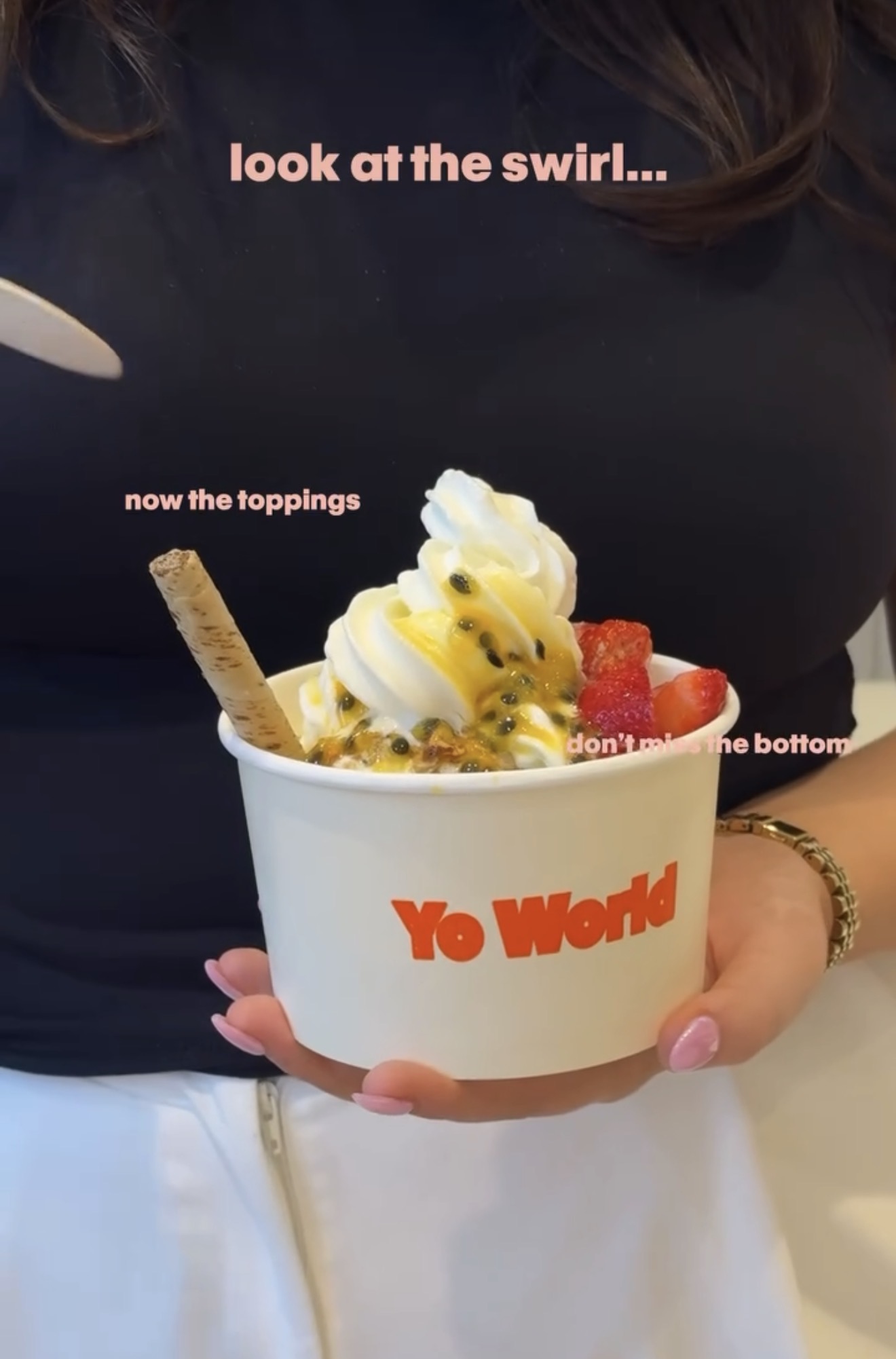 A Yo World frozen yoghurt bowl topped with passionfruit and strawberries